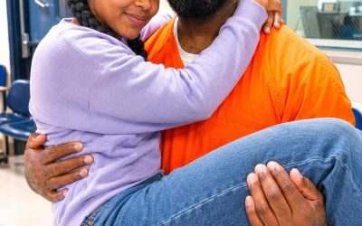 I married a prisoner for money while he was serving a twelve-year sentence — but after his conviction was overturned, he came to my apartment with a black box and said, “Now it’s my turn to be honest.” When I agreed to marry Jonah, I didn’t care whether he was innocent. He had been convicted of stealing from his family’s charity. I was twenty-seven, drowning in rent notices and raising my brother. So when Jonah’s mother offered me ,000 a month to become his wife on paper, I said yes before shame could catch up with me. “Visit twice a month,” she said. “Write letters. Make the court see he still has family.” Our wedding happened behind scratched glass, with a guard watching the clock. I expected Jonah to be angry. Cold. Maybe cruel. But he was gentle. He remembered my brother’s birthday, asked if I had eaten, and sent notes with sketches in the margins. At first, I only acted like I cared. Then I stopped acting. I started reading his case files at night. Missing signatures. Dates that didn’t match. A witness who left the state after testifying. When everyone else called Jonah a thief, I stood outside courthouses with folders in my arms, begging lawyers to take another look. Jonah never asked why. By then, I loved him. Three years after our prison wedding, the truth came out. His cousin had moved the charity money, forged Jonah’s name, and let him take the blame. The day Jonah walked free, I thought he would run into my arms. Instead, his face tightened, as if freedom itself had bruised him. Then he took my hand and said, “Come home with me.” For one week, I believed we had survived the worst of it. Then, on the eighth night, Jonah placed a black box on our kitchen table. “What is that?” “Now it’s my turn to be honest.” I tried to smile. “Jonah, don’t scare me.” His expression shifted, and my skin went cold. “Yes,” he whispered. “I have to. Because when you married me, you agreed to something far BIGGER than a name on paper.”